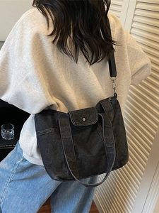 Retro denim tote bag in black denim with shoulder strap and metal buckle pocket