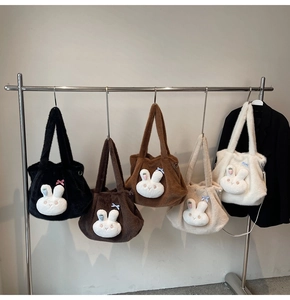 Detailed row of plush rabbit tote bags in five different colors on a sleek metal rack