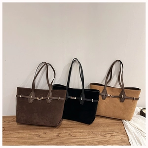 Detailed view of large tote bags in dark brown, black, and light camel suede finishes