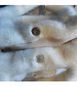 Close-up of the secure magnetic snap closure on the white plush rabbit tote bag details
