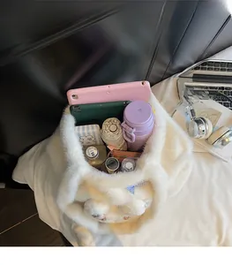 Macro view of white plush tote bag interior showing high capacity for tablets and bottles