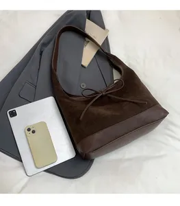 Deep brown retro hobo bag shown with iPad and phone for size comparison and capacity view