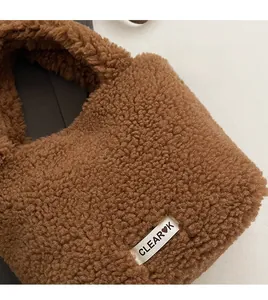 Close-up of brown plush teddy bucket bag featuring thick caramel lamb wool texture