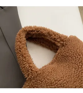 Close-up of the plush brown faux fur handle and soft texture of the bucket bag