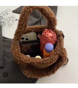 Interior view showing the large capacity of this brown plush teddy crossbody bucket bag