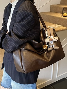Large dark brown vintage leather tote bag with a cute rabbit pendant shown on model