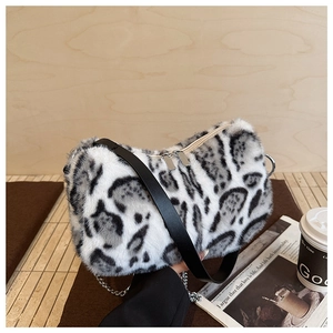Close-up of leopard print faux fur shoulder bag with leather strap and silver chain