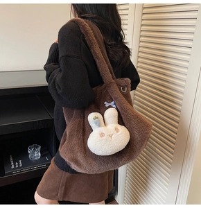 Detail of soft brown plush tote bag featuring a cute rabbit charm and blue plaid bow