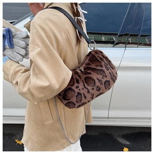 Detail of leopard print faux fur shoulder bag with chain and leather strap