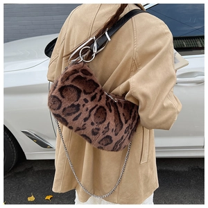 Detail of plush leopard print shoulder bag featuring metal chain and faux fur texture