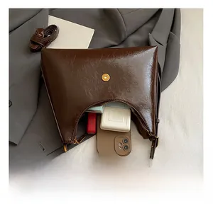 Interior view showing the large capacity of the brown retro pleated shoulder bag