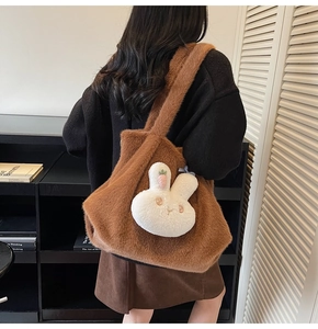 Detailed back view of a fuzzy brown tote bag featuring a cute white rabbit plush charm
