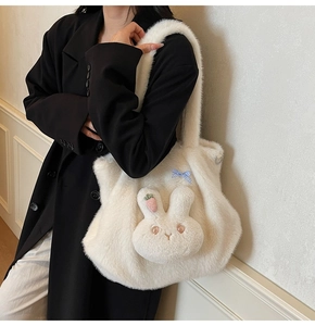 Close-up of white plush tote bag featuring a 3D bunny design with a blue checkered bow