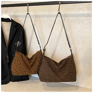 Detail of hobo tote bags featuring classic and dark brown leopard print patterns