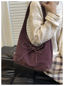 Detail view of the vintage purple suede tote bag with bow tie and leather trim