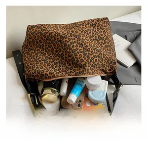 Spacious interior of leopard print tote bag with tablets, books and cosmetics