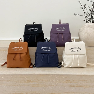 Detail showing various colors of nylon backpacks with drawstring flap and C&honey branding