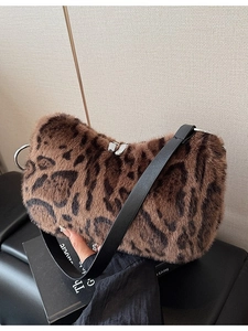 Fashionable leopard print faux fur shoulder bag with black leather strap and silver zippers