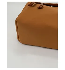 Detail of camel backpack reinforced base with sturdy structure and leather drawstring