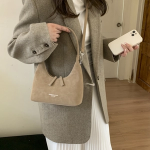 Khaki suede hobo bag styled with a grey blazer and pleated skirt for office look