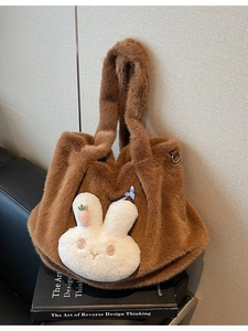 Brown fluffy tote bag with cute white bunny charm and leather strap details