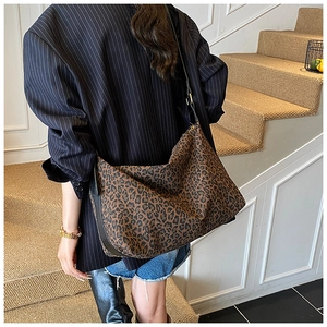 Detail of leopard print hobo bag with adjustable leather strap and golden buckle