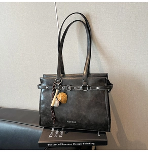 Detail of vintage grey leather bag with baseball theme charms and Muon SharK logo imprint