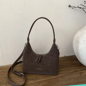 Detail of vintage brown crescent bag with silver hardware and fashion leather embossing