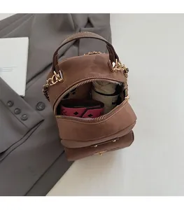 Interior view showing the large capacity of this brown vintage backpack with metal handles