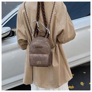 Rear view of a mini brown leopard backpack with cat ears and gold chain straps