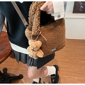 Brown fuzzy faux fur bucket bag with cute bear charm and adjustable crossbody strap