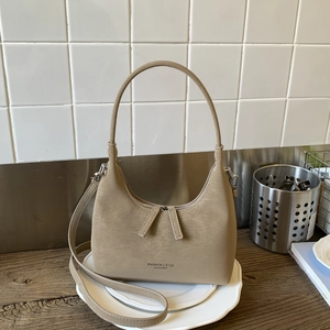 Minimalist beige hobo shoulder bag with dual straps and smooth faux leather texture