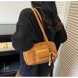 Brown frosted suede shoulder bag with retro wooden beads detail and front pocket