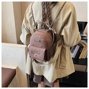 Detail view of the cat-shaped leopard print backpack featuring a golden twist lock closure