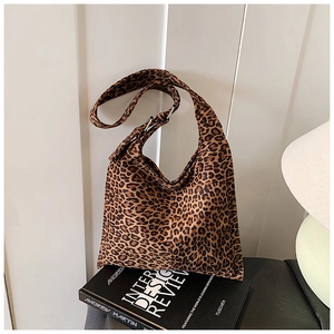 Detail view of leopard print canvas tote bag side pocket on vintage book display