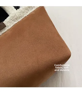 Close-up of brown faux suede bucket bag with soft cream fleece trim and texture detail