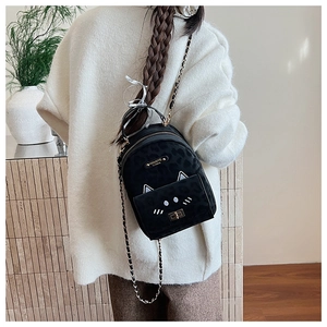 Detail of a black leopard print mini backpack featuring cute cat ear design and chain strap