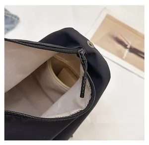 Detail of smooth black nylon backpack zipper and internal zip pocket compartment