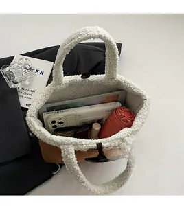 Spacious interior of suede and fleece bucket bag showing tablet and accessories