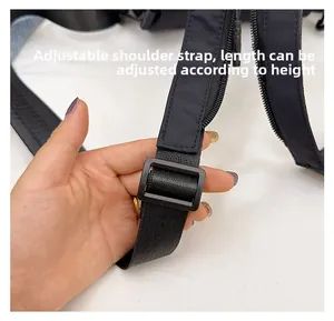 Close-up of adjustable black nylon shoulder strap with plastic buckle for custom fit