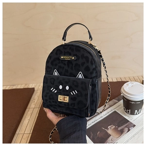 Detail of black leopard jacquard backpack with cat ear embroidery and gold twist lock