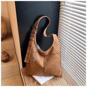 Detail of adjustable silver buckle and stitching on brown suede hobo shoulder bag
