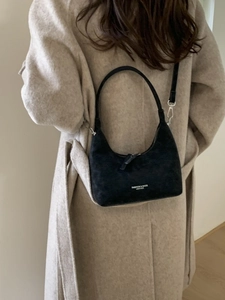 Suede black hobo bag for women with fashion text logo, styled with a beige coat