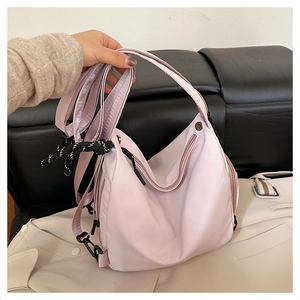 Light purple waterproof nylon backpack detail with multi-strap hooks and zippers
