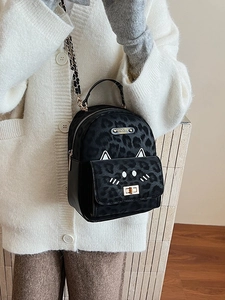 Cute black leopard cat mini backpack with cat ears and gold chain strap on model