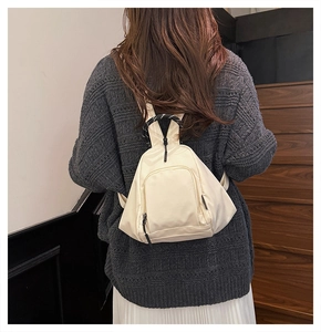 Outdoor waterproof mini nylon backpack for women shown in a casual lifestyle outfit
