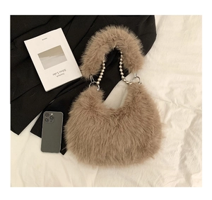 Detail of light brown faux fur bag showing soft texture and silver beaded chain strap