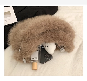 Detailed interior view of a fluffy brown faux fur half-moon bag filled with daily items