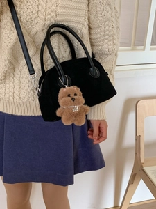 Retro black bowling handbag with plush dog charm and crossbody strap for autumn style