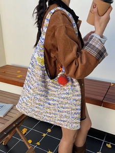 Rainbow knit tote bag with colorful texture and red pendant for autumn styling